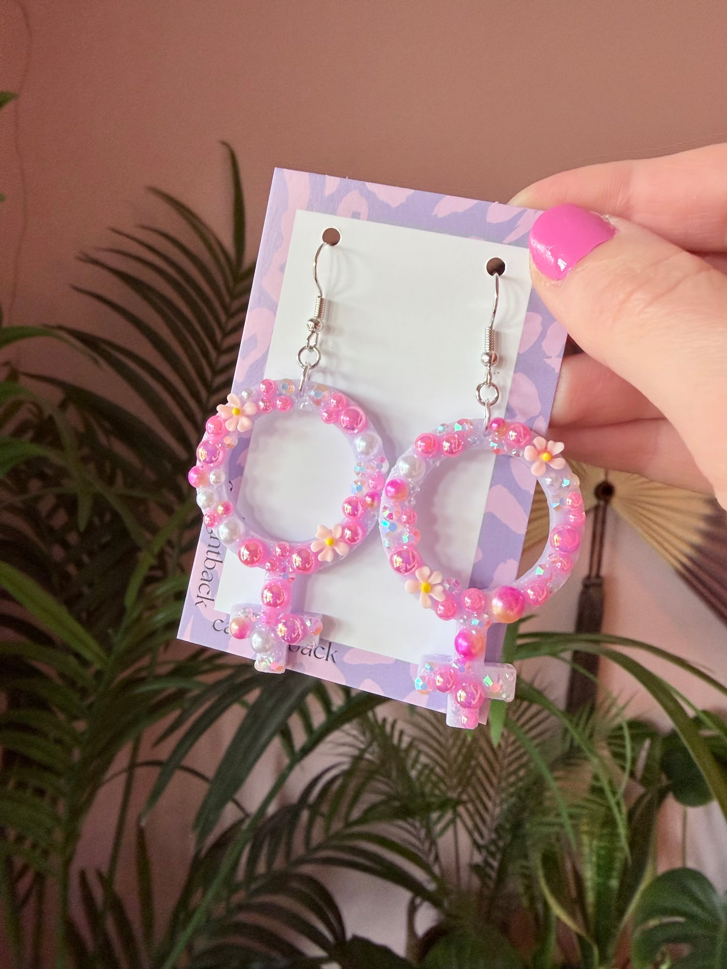 Rosa Kvinnotecken med Rhinestones och Blommor