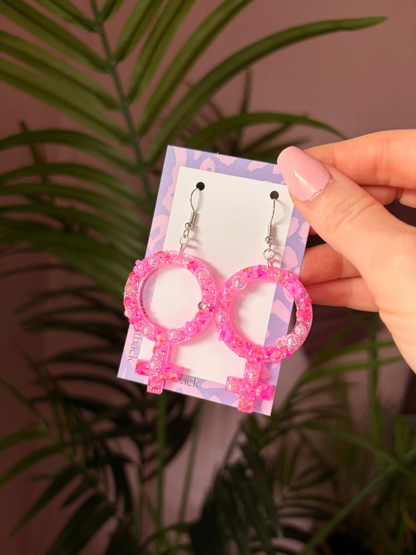 Rosa Kvinnotecken med Blommor och Rhinestones