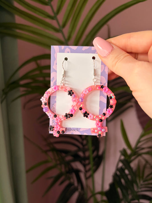 Rosa Kvinnotecken med Blommor och Rhinestones