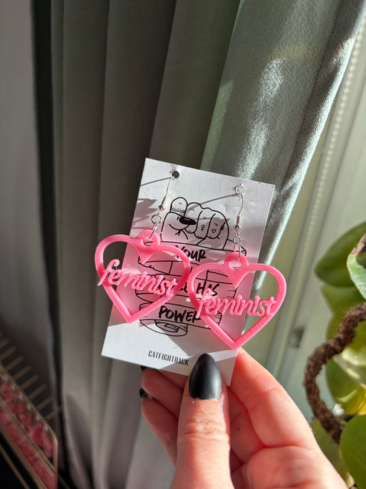 Rosa hjärtan med texten feminist