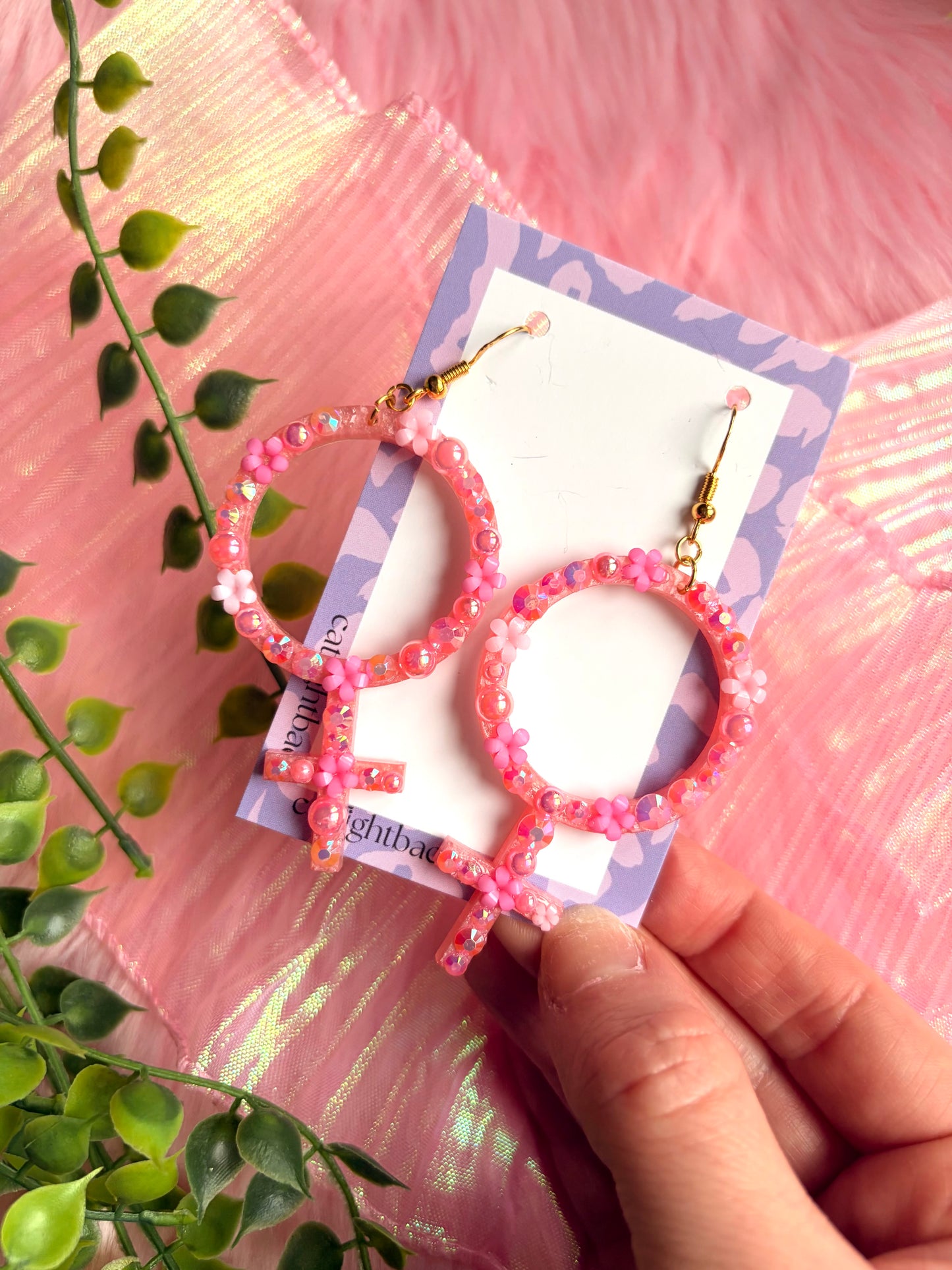 Rosa Kvinnotecken med Blommor och Rhinestones
